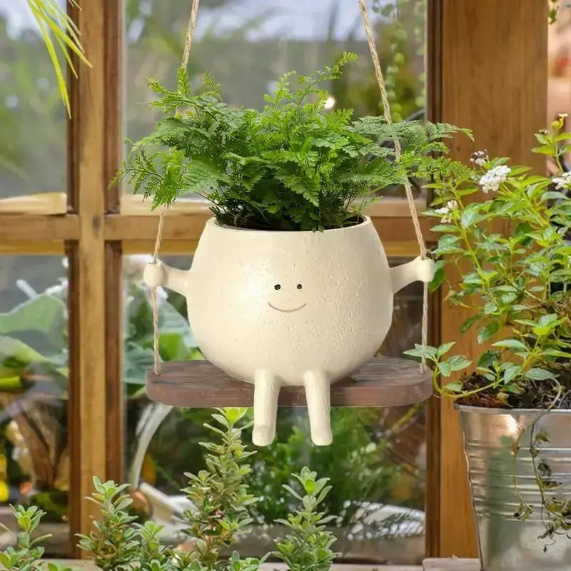 Swing Face Planter Pot erfect for displaying your favorite plants or flowers, this pot is a versatile addition to any room in your home. The swing design adds an element of playful elegance, My Store