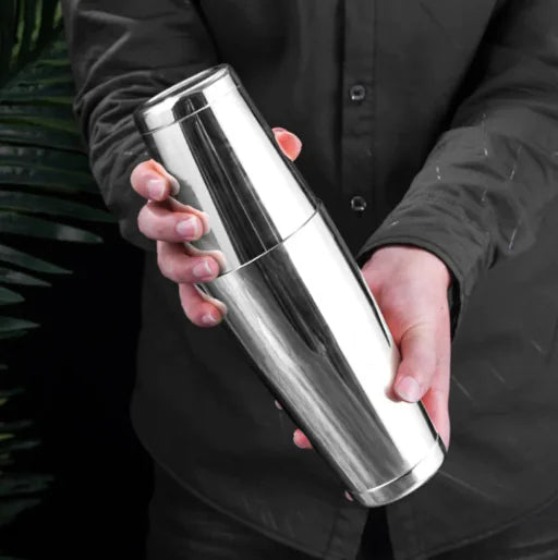 Person holding a silver insulated tumbler